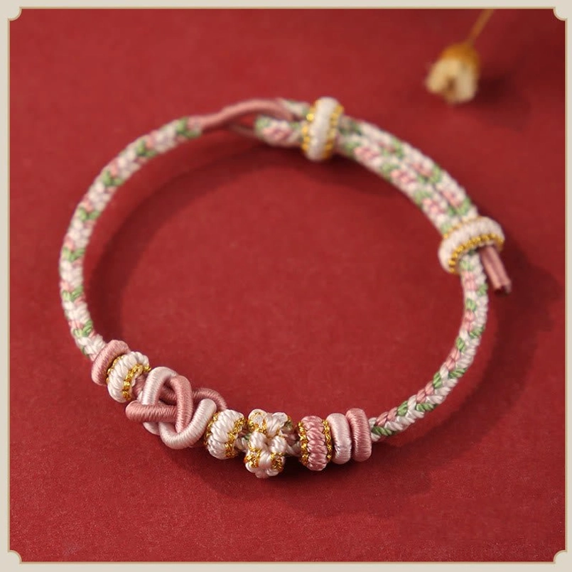 Pastel Pink Peach Blossom Peace Knot Red String Bracelet Flat Lay