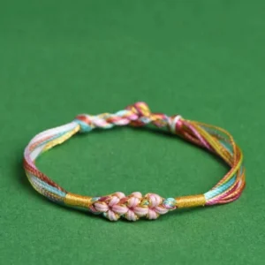 Pastel rainbow braided red string bracelet with pink peach blossom knot front view