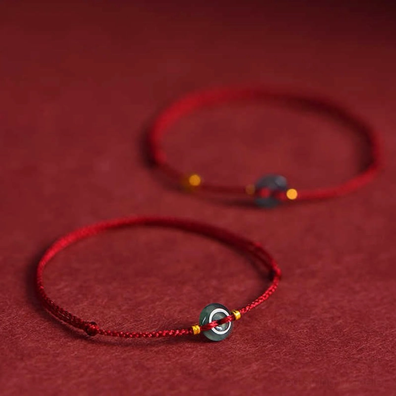 Multiple jade peace buckle red string bracelets - flat lay showing single and dual charm design variations