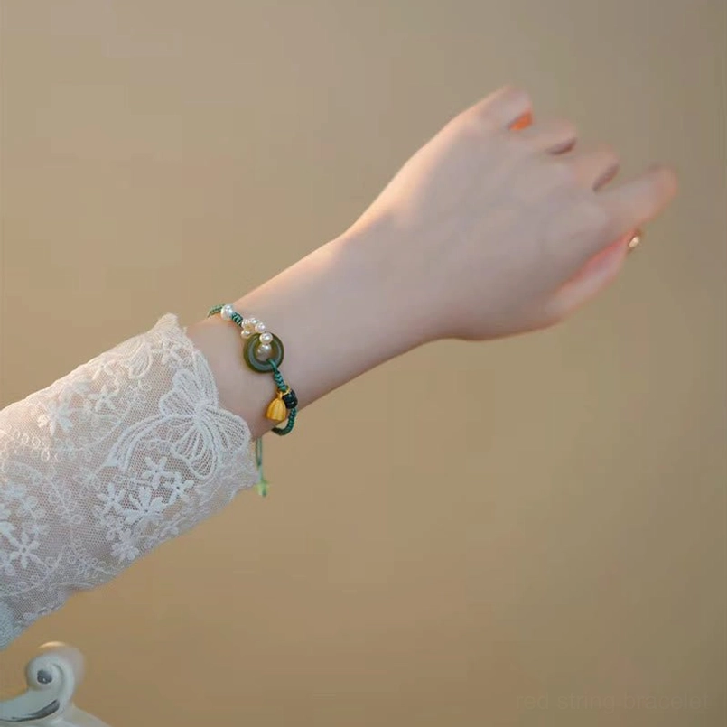 Adjustable braided jade bracelet back view on bare wrist with lace cuff