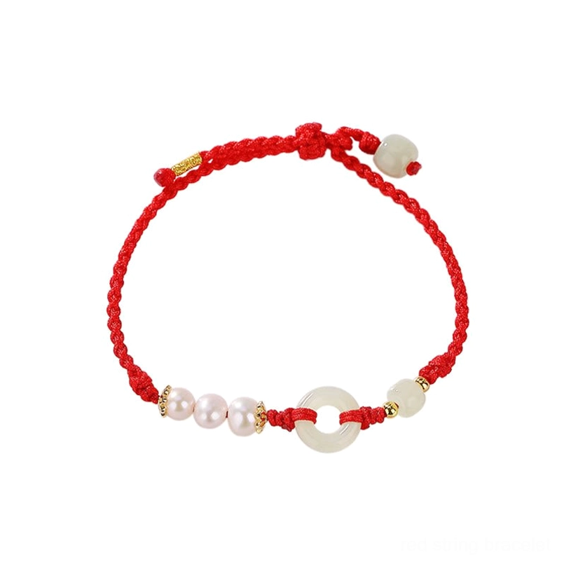 Symmetrical layout peace buckle red string bracelet flat lay on red background