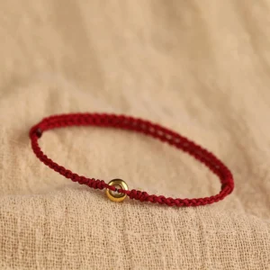 999 gold peace buckle red string bracelet top view with braided cord and gold charm