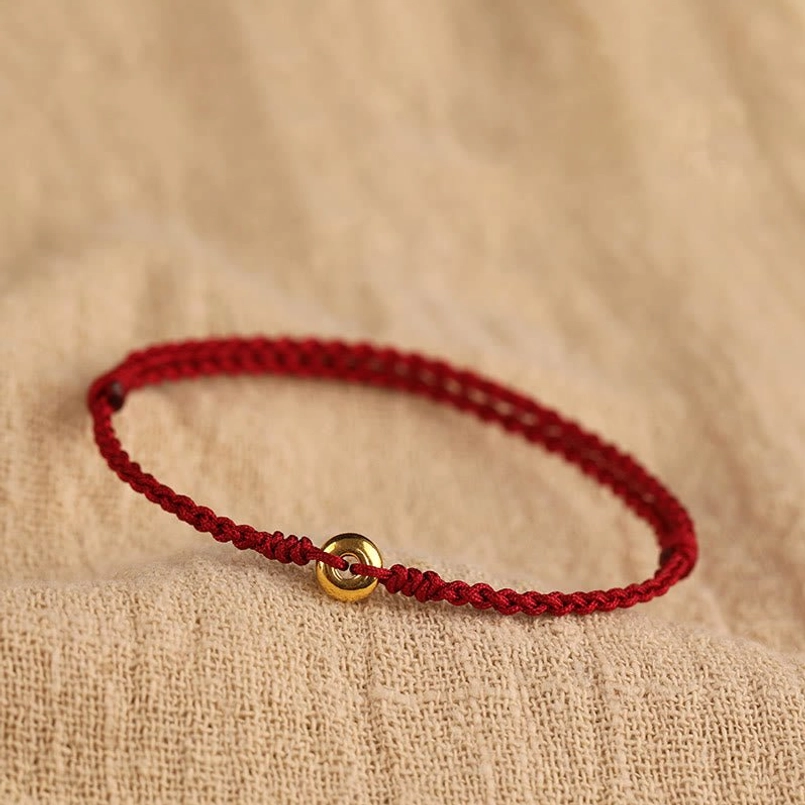 999 gold peace buckle red string bracelet top view with braided cord and gold charm