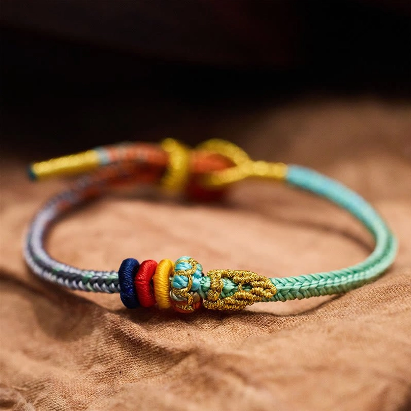 Top view of Tibetan lucky bracelet showing gold accents and adjustable cord design