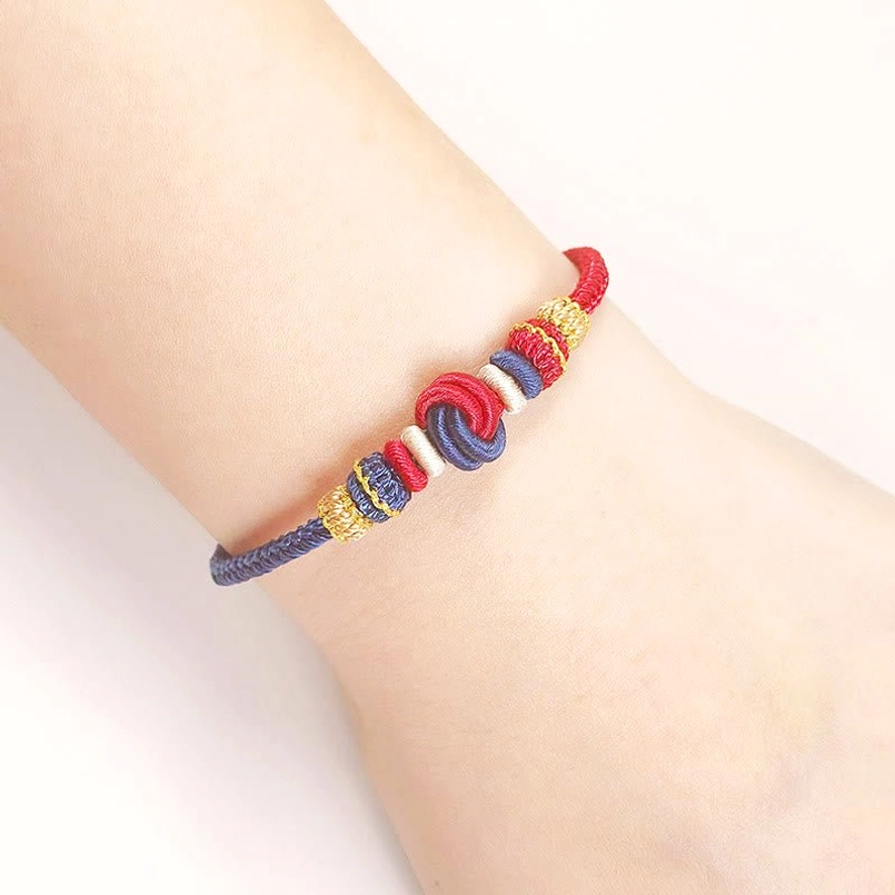 Eight thread peace knot bracelet worn on wrist showing multicolor braided design in daily wear style