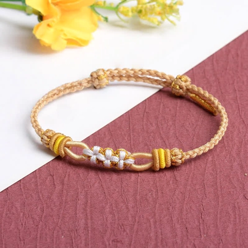 Khaki beige braided peach blossom luck bracelet with white and gold flower knot details adjustable cord