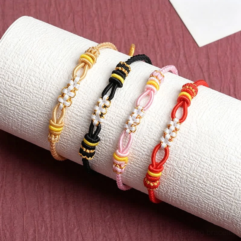 Four pack handmade peach blossom bracelets red black pink beige with flower knot details on white roll
