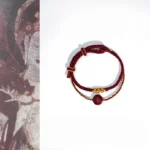 Peach blossom cinnabar red string bracelet eight-strand braided blessing with ancient mural background