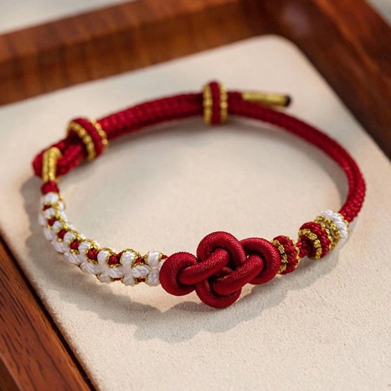 Adjustable red string bracelet with gold peach blossom charm and white beaded chain segments