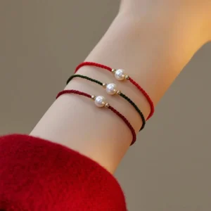Pearl red string bracelet multicolor strands overhead wrist view natural pearls gold beads
