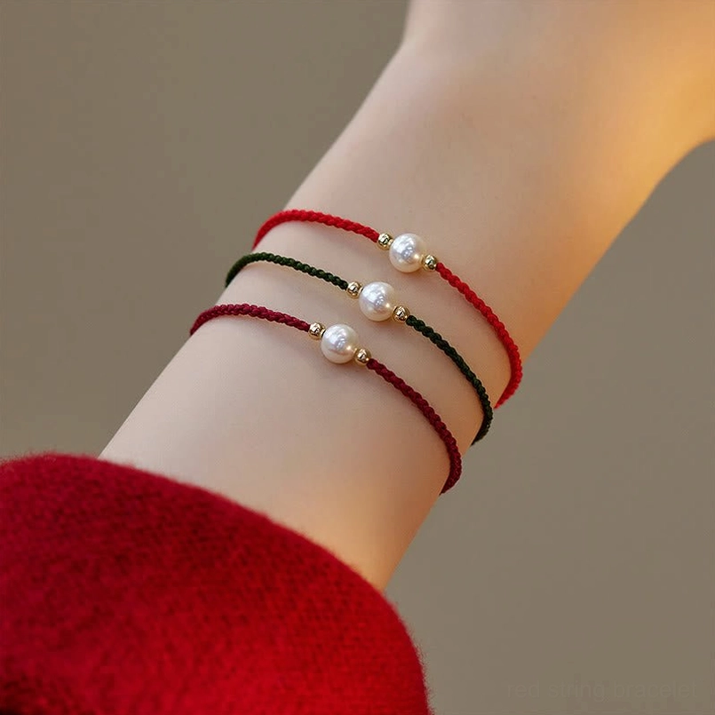 Pearl red string bracelet multicolor strands overhead wrist view natural pearls gold beads