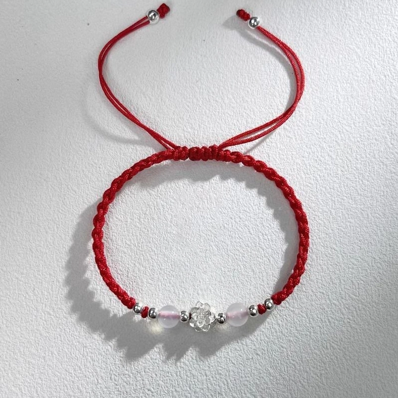 red braided protection bracelet with pink cat's eye beads and silver lotus