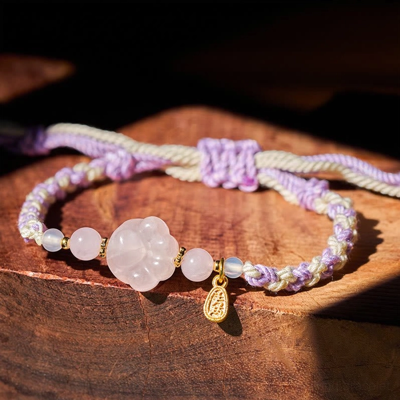 Pink Crystal Cat Paw Braided String Bracelet main view on wooden table