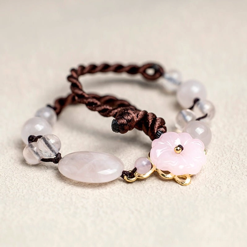 Two stacked pink crystal flower anklets showing layered jewelry styling options
