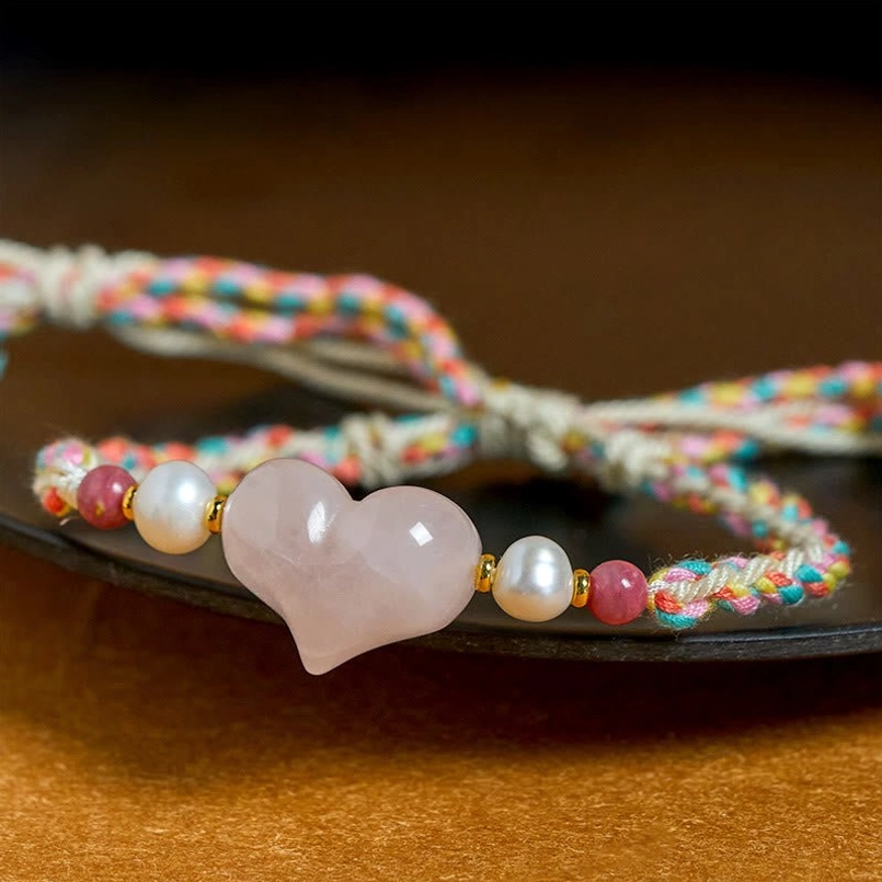 Close Up View Of Natural Heart Pink Crystal Charm On Red String Bracelet