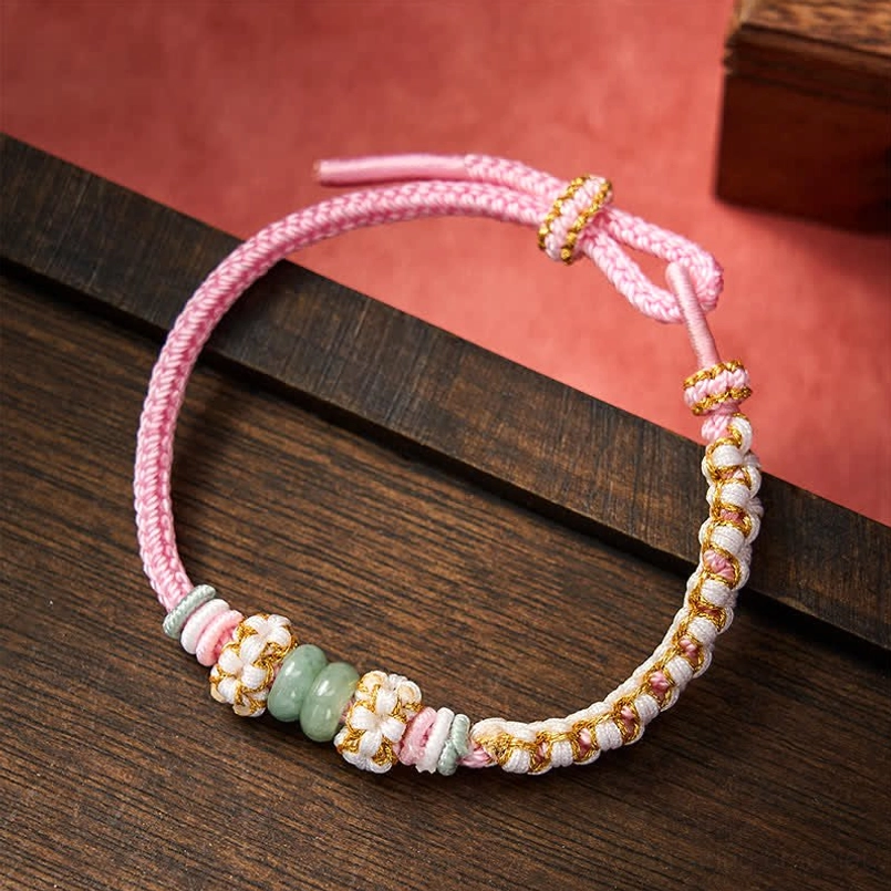 Pink handmade luck bracelet with adjustable knot and jade details