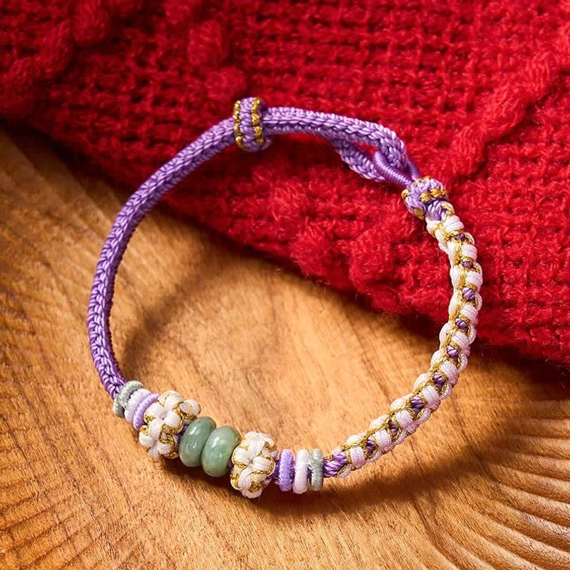 Pink string bracelet with traditional knot work and protective jade