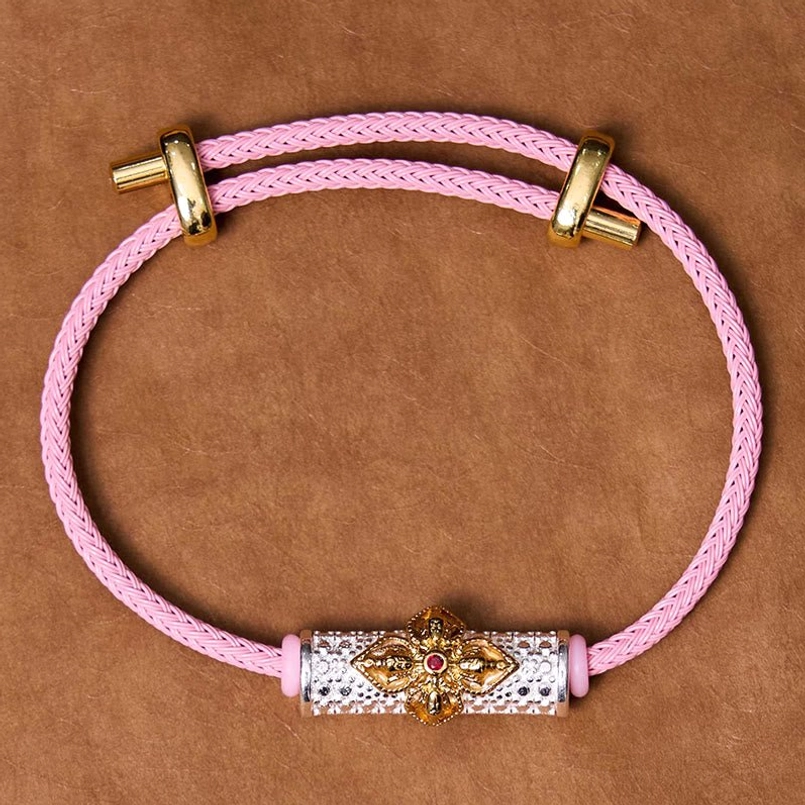 Pink string bracelet variant with colorful enamel flower and metal accents