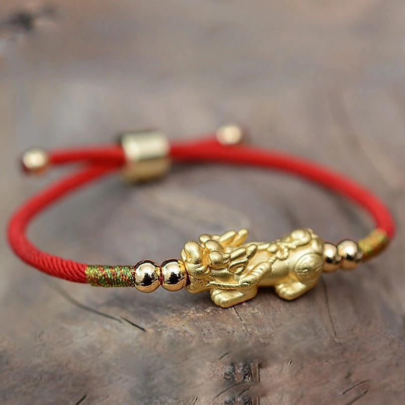 Pixiu wealth bracelet with red rope and decorative gold beads detail