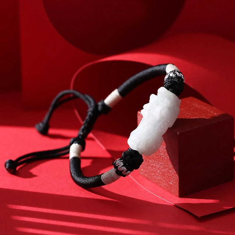 Jade Pixiu wealth talisman on braided string - side low angle showing charm design
