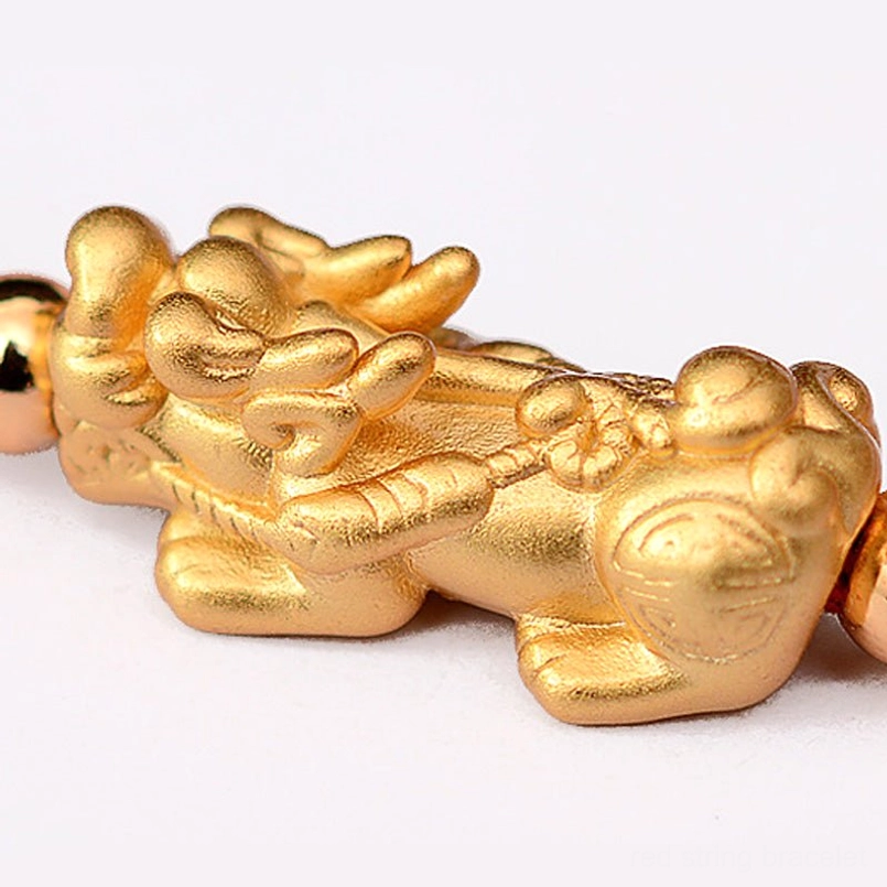 Pixiu charm underside showing fortune character engravings and coin motifs