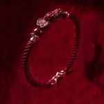 Dark red braided Pixiu cinnabar wealth bracelet with 925 silver clasp, side view