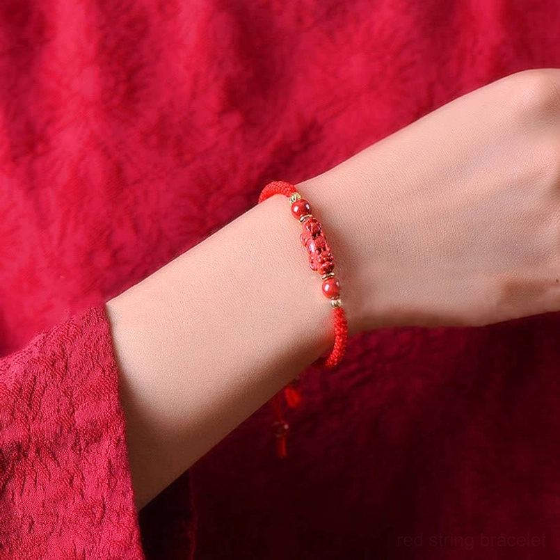 Red string cinnabar Pixiu bracelet worn on wrist showing natural fit and comfort