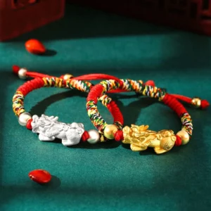 999 Sterling Silver Pixiu kids bracelet flat lay with red and multicolor braided rope options