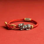 925 Sterling Silver Pixiu Om Mani Padme Hum red string protection bracelet with engraved charm on solid red background