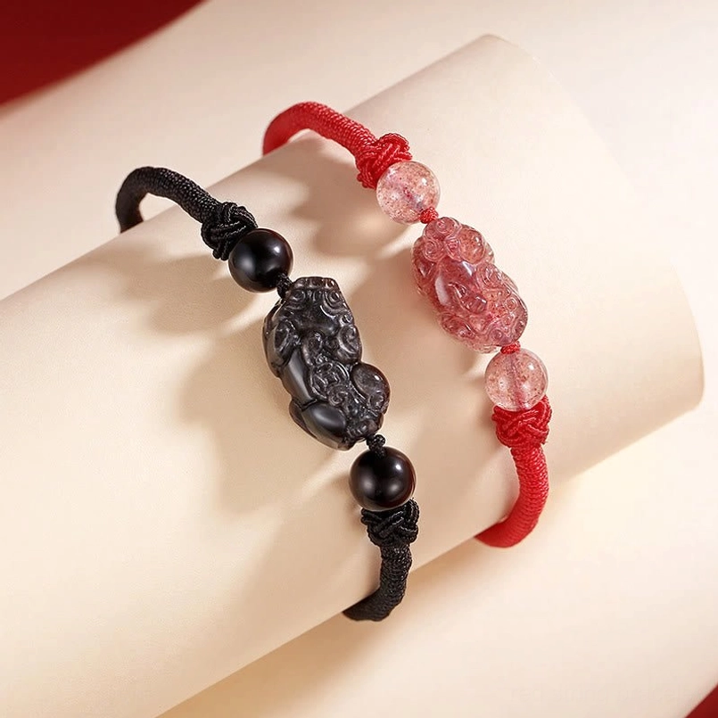 Pixiu braided bracelets worn on arm model silver sheen obsidian and strawberry quartz variants
