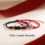 Pixiu couple braided bracelets red and black cord with obsidian and strawberry quartz charms flat lay