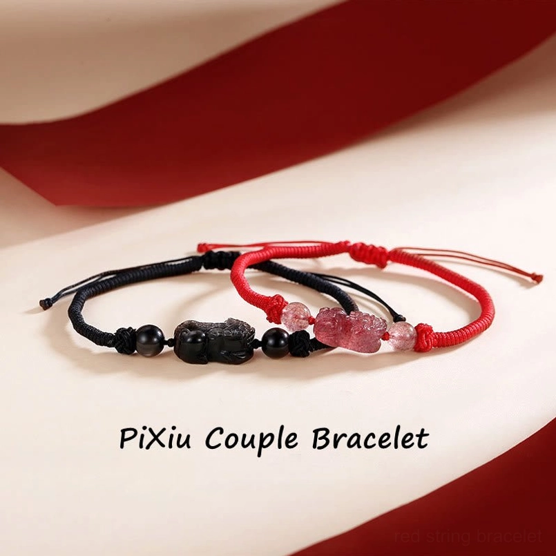 Pixiu couple braided bracelets red and black cord with obsidian and strawberry quartz charms flat lay