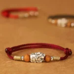 999 Sterling Silver Pixiu Peach Wood Bead Red String Bracelet - Flat Lay Front View