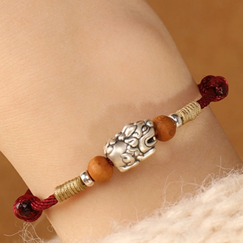 Red String Pixiu Bracelet Worn on Wrist - Lifestyle Flat Lay