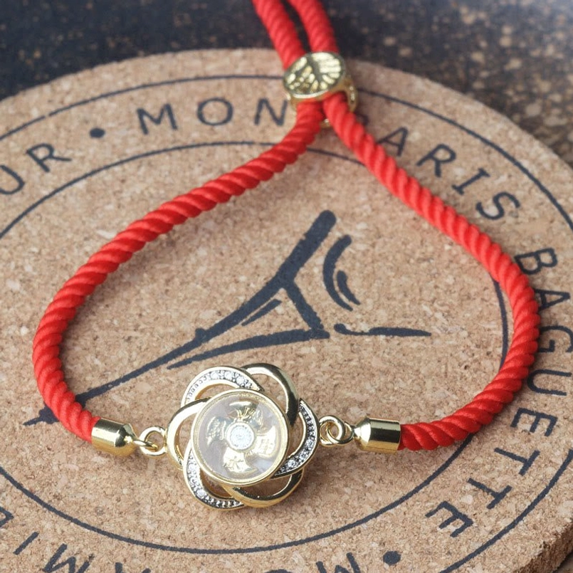Plum blossom windmill red string bracelet side view of brass charm