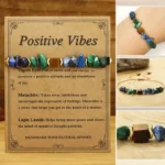 Positive Vibes natural stone bracelet with malachite tiger's eye and lapis lazuli beads on light wood background
