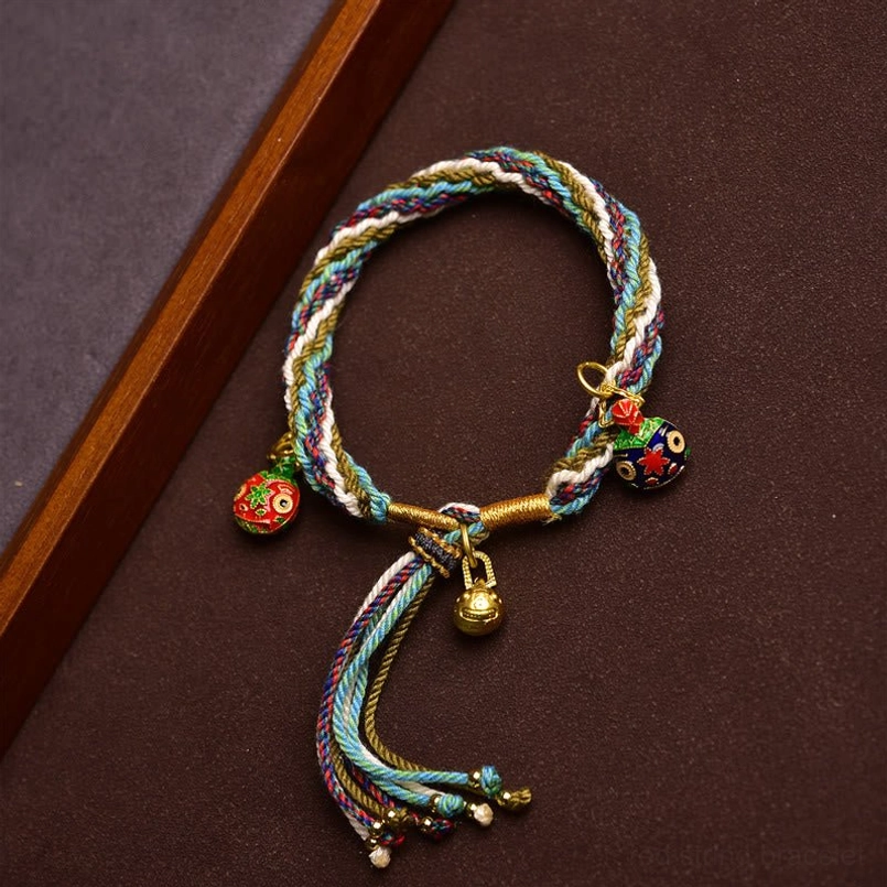 Side view of family protection red string bracelet with Swallowing Beast charms