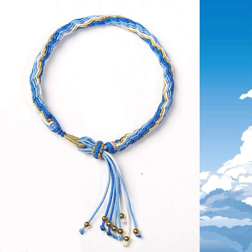 Blue and gold thread hand-woven protective bracelet with metal bead tassel and luck-enhancing design