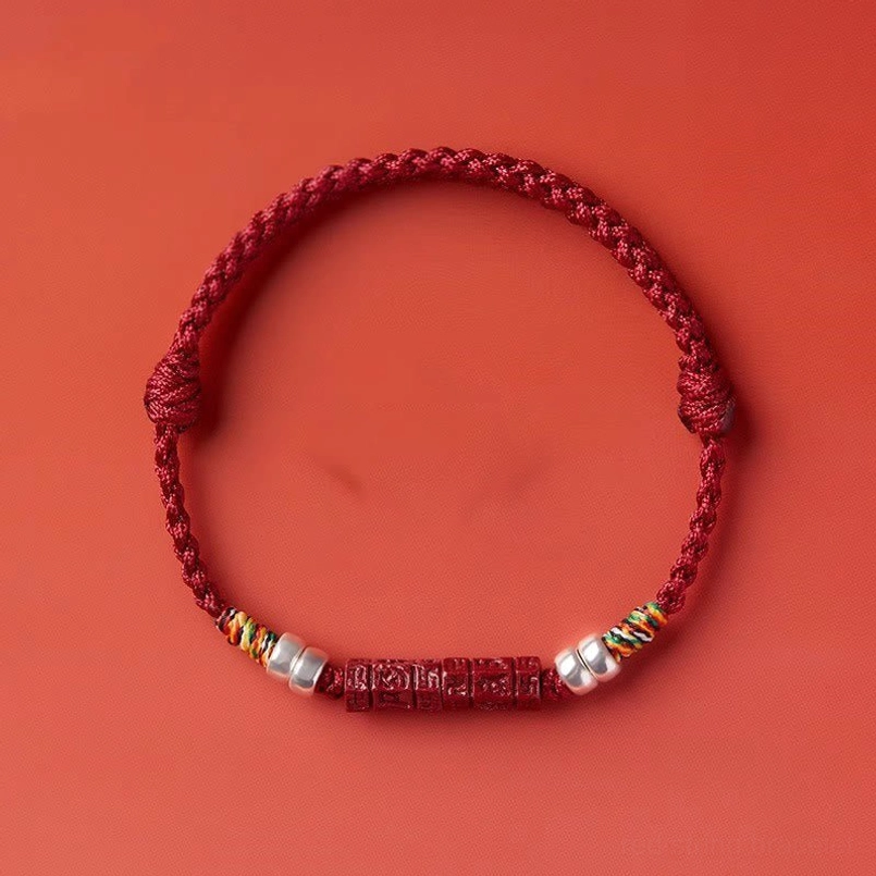 Protective red string bracelet with handcrafted details and spiritual significance