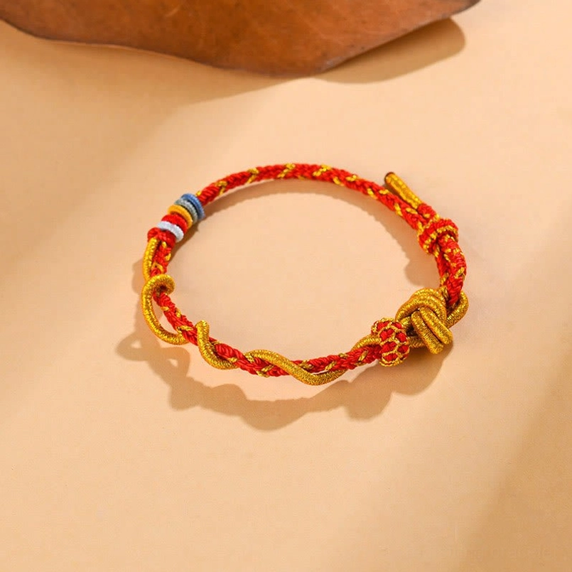 Protective red string Snake Year bracelet with intricate knot work and spiritual energy