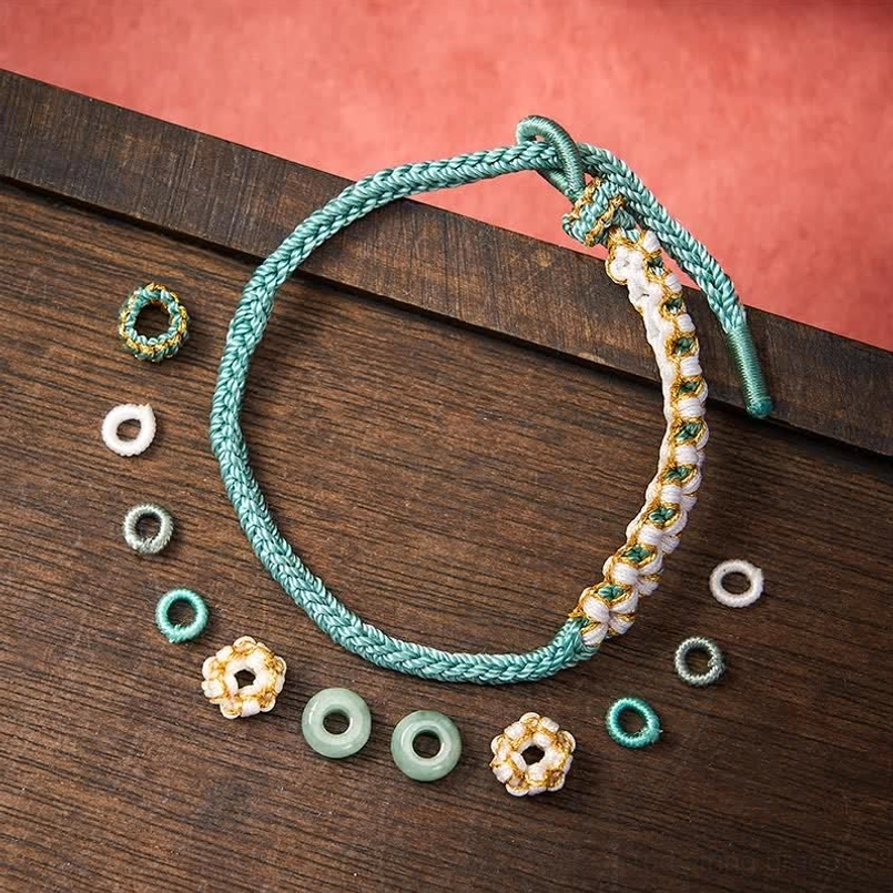 Purple handmade string bracelet with traditional knotting and jade detail