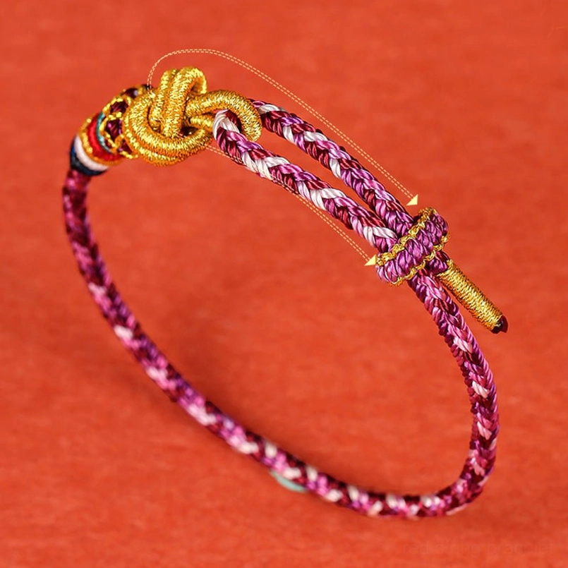 Adjustable handwoven protection bracelet with purple cord and sliding golden knot buckle