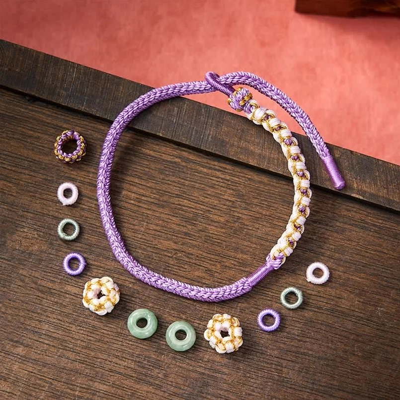 Purple string bracelet adjustable cord displayed with styled background