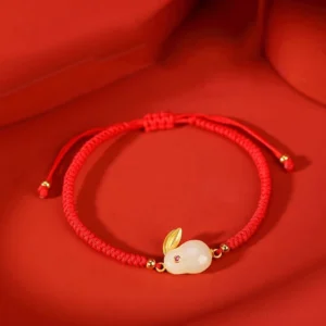 Year of the Rabbit Hetian white jade red string protection bracelet with 925 sterling silver gold-plated charm on red fabric