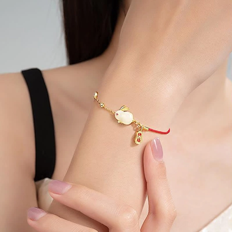 Year of the Rabbit red string bracelet worn on wrist natural on-body shot