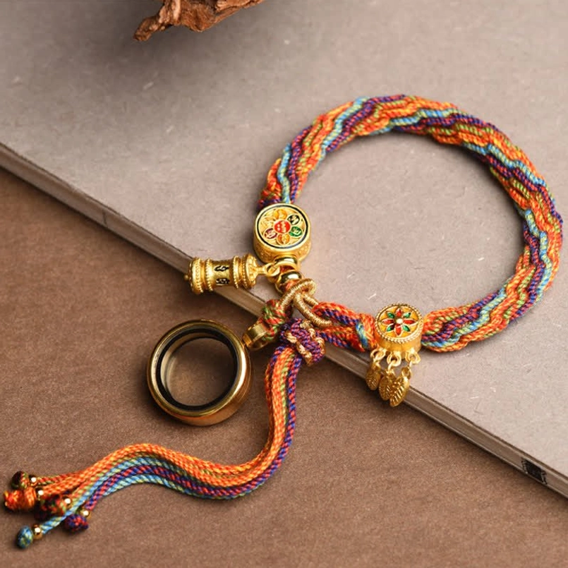 Colorful rainbow braided Tibetan lucky bracelet side view on light grey panel