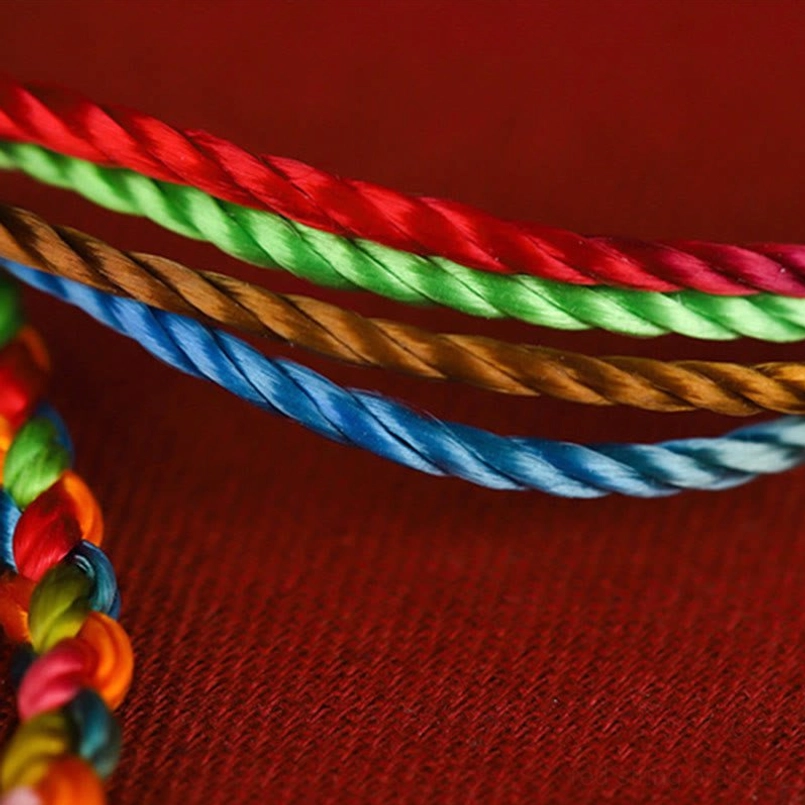 Multicolored silk braided strands showing 4-color twisted design with smooth satin finish