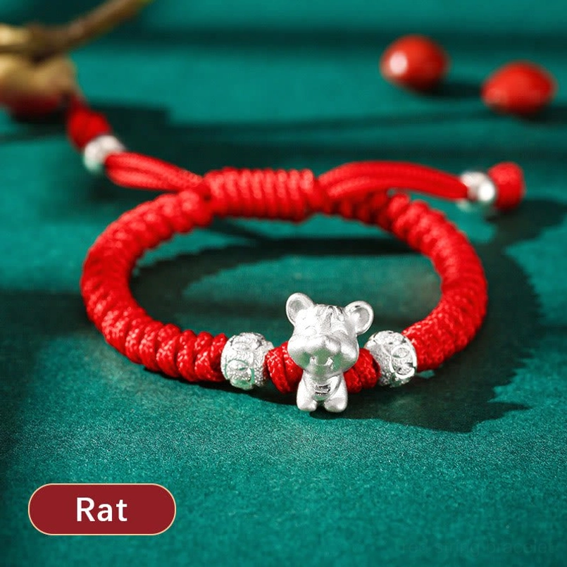 Rat Chinese zodiac 999 sterling silver red braided rope bracelet flat lay with decorative props