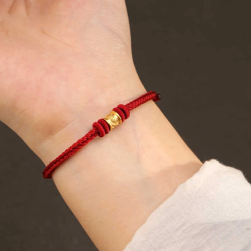 Real wearing shot of red string Tibetan luck protection bracelet on wrist