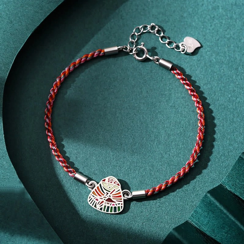 Red braided 925 sterling silver zongzi charm red string bracelet flat lay on dark green background